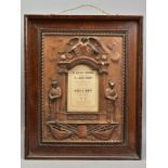 A LARGE WOODEN AND PLASTER OF PARIS WALL PLAQUE, with a central area which houses a period card