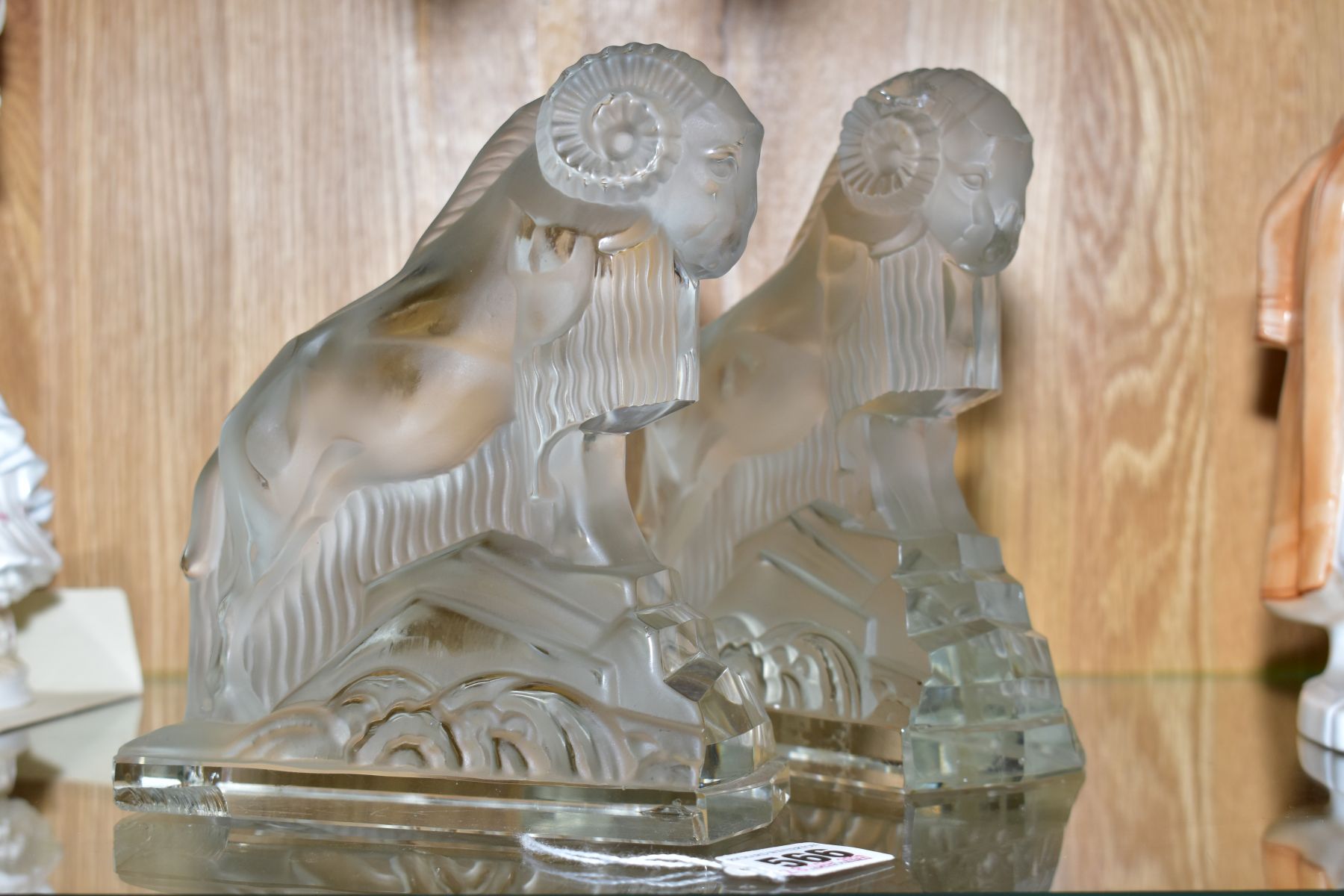 A PAIR OF ART DECO FROSTED GLASS FIGURES OF RAMS, on rectangular clear glass bases, height ????, (