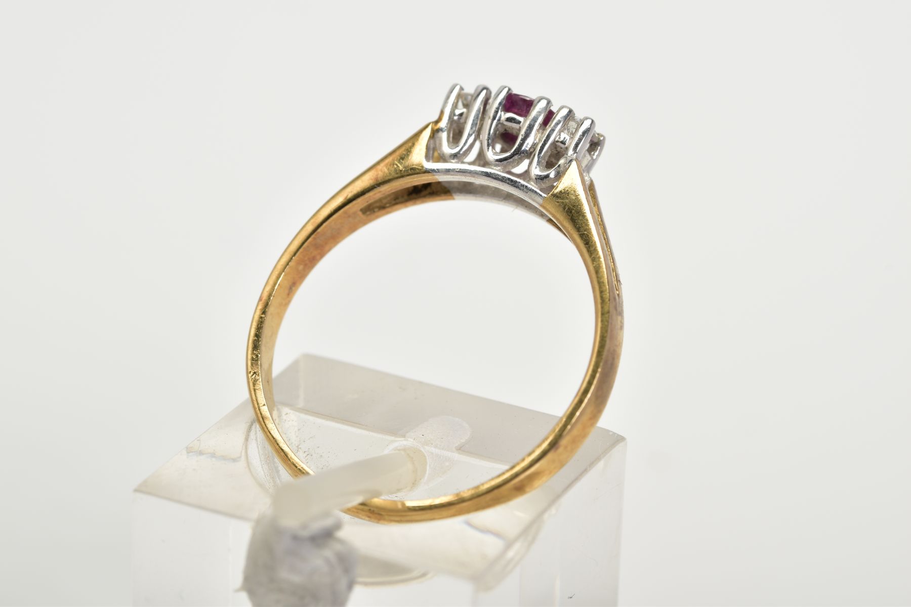 A 9CT GOLD THREE STONE RING, designed with a central claw set circular cut ruby flanked by round - Image 3 of 3