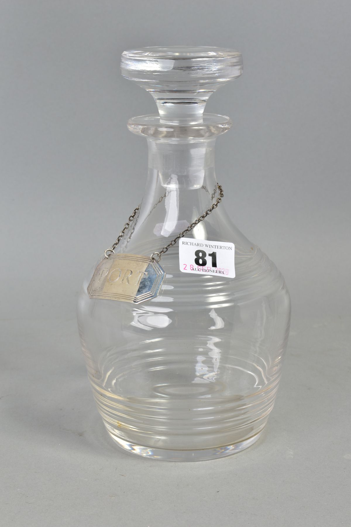 A GLASS DECANTER AND SILVER LABEL, glass decanter with stopper, height approximately 22cm,