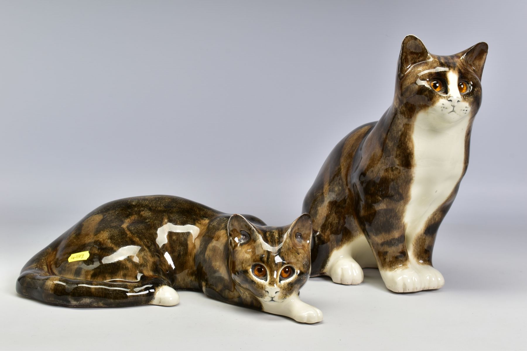 TWO LARGE MIKE LINTON POTTERY CATS, one seated, height 29cm (ear restored) and the other lying,