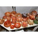 A COLLECTION OF CARNIVAL GLASS, orange, green and amethyst including grapes and vine (green),