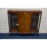 AN EARLY MID 20TH CENTURY BURR WALNUT THREE DOOR CHINA CABINET, glass shelves, with a central bow