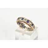 A 9CT WHITE GOLD SAPPHIRE ETERNITY RING, the central white gold panel set with square cut