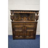 A REPRODUCTION OAK COURT CUPBOARD, the top section with a single cupboard door, between two acorn