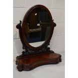 A VICTORIAN MAHOGANY OVAL TOILET MIRROR, with a serpentine base, width 71cm x height 84cm