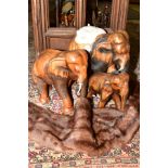THREE CARVED WOODEN AFRICAN ELEPHANTS OF GRADUATING SIZES, approximate tallest height 48cm, together
