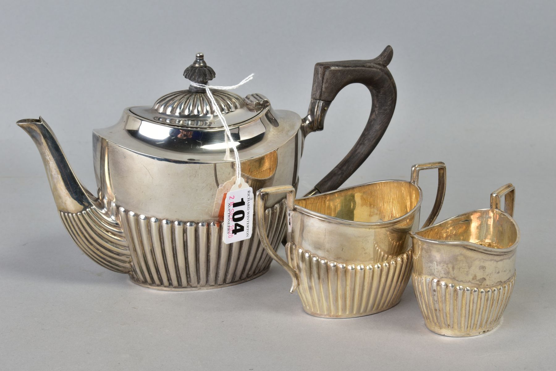 A LATE VICTORIAN SILVER THREE PIECE BACHELORS TEA SET, of oval form, stop reeded decoration,