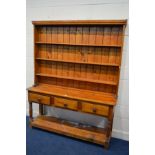 A DISTRESSED PITCH PINE DRESSER, with three drawers, width 154cm x depth 40cm x height 194cm