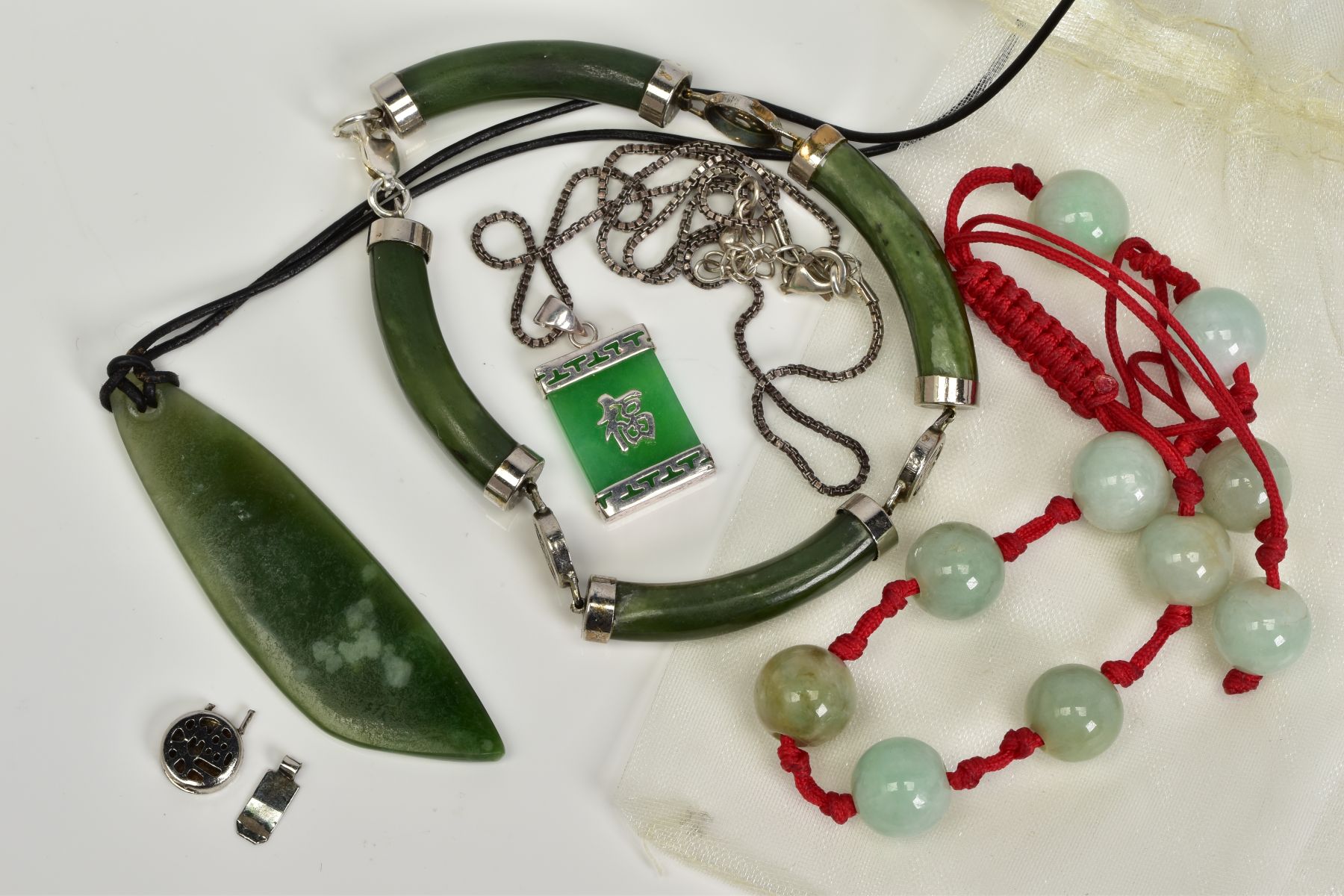 A SELECTION OF JADE AND NEPHRITE JEWELLERY, to include a beaded assessed as jade adjustable bracelet