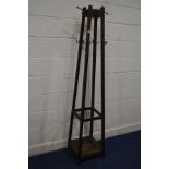 AN EARLY 20TH CENTURY ARTS AND CRAFTS OAK SQUARE TAPERING HALL STAND, with multiple brass hooks,