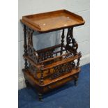 A VICTORIAN BURR WALNUT CANTERBURY, having a gallery top, on a pair of foliate scrolling and