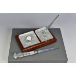 A BOXED WATERFORD CRYSTAL DESK SET, comprising a quartz clock and a pen stand with pen set in a