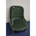 A LATE VICTORIAN GREEN UPHOLSTERED BEDROOM CHAIR on ceramic casters