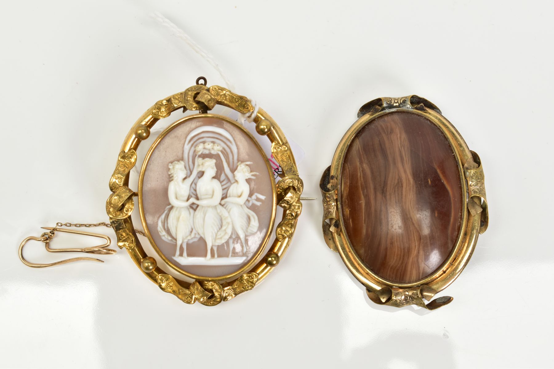 TWO YELLOW METAL BROOCHES, to include a cameo swivel memorial brooch, the cameo depicting the