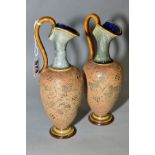 A PAIR OF ROYAL DOULTON STONEWARE EWERS, blue and brown glazed handle and spout, impressed lace