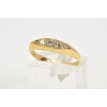 A YELLOW METAL DIAMOND BOAT RING, designed with five graduated diamonds with a central round
