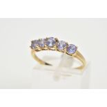 A 9CT GOLD FIVE STONE RING, of half hoop design set with five claw set circular cut amethyst, to the