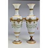 A PAIR OF LATE 19TH CENTURY OPAQUE WHITE GLASS, GILT AND GREEN JEWELLED TWIN HANDLED BALUSTER VASES,