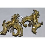 A PAIR OF CAST BRASS CHERUBS ON ROCOCO SUPPORTS, possibly from a fireside fender height