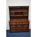 AN OLD CHARM OAK LINENFOLD DRESSER with three drawers, width 136cm x depth 44cm x height 176cm