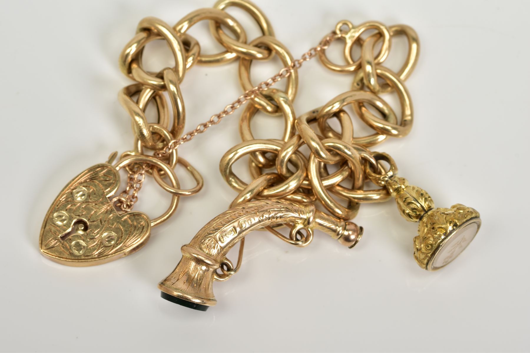 A 9CT GOLD CHARM BRACELET, the charm bracelet which suspends two charms, the first a fob seal - Image 2 of 4