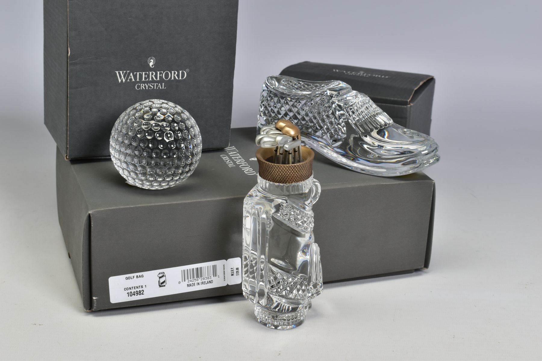 A WATERFORD CRYSTAL BOXED GOLFING THEME SET, comprising a golf bag and clubs, height 13.5cm, a