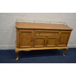 A MODERN LIGHT WOOD SIDEBOARD with decorative veneers to door and drawer panels, brass adornments on