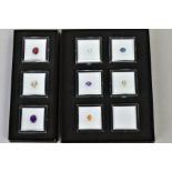 A SMALL SELECTION OF GEMSTONES, to include a box of three oval cut stones assessed as amethyst,