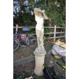 A LARGE COMPOSITE GARDEN FIGURE OF A GRECIAN LADY standing on a seperate round column base, height