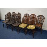 A HARLEQUIN SET OF ELEVEN OAK WHEELBACK CHAIRS