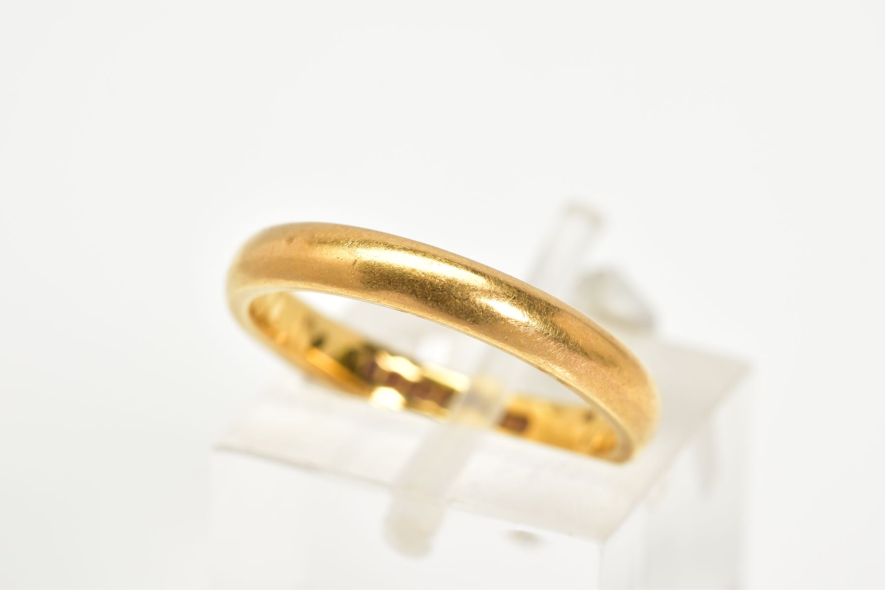 A 22CT GOLD BAND, the plain polished band with a 22ct hallmark for Birmingham, ring size K,