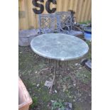 A MODERN GARDEN TABLE with a cast iron base in the form of four shaped Victorian style legs bolted
