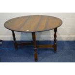 A MODERN SOLID OAK OVAL GATE LEG TABLE with turned legs, open length 122cm x closed 31cm x depth