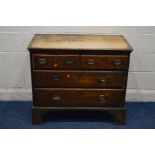 A DISTRESSED GEORGIAN OAK CHEST OF TWO OVER TWO DRAWERS, brass handles and escutcheons on high