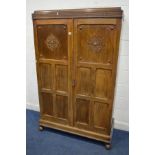 A MID 20TH CENTURY OAK DOUBLE PANELLED DOOR WARDROBE, with raised fretwork decoration, width 116cm x