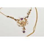 A YELLOW METAL OPENWORK PENDANT NECKLACE, the openwork floral pendant set with split pearls and