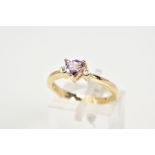 A 9CT GOLD AMETHYST AND DIMAOND RING, designed with a claw set triangular cut amethyst, flanked with