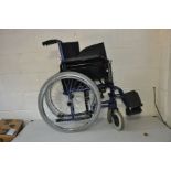 AN EXCEL 100 BASIC QR WHEELCHAIR with electric blue finish and two feet rests
