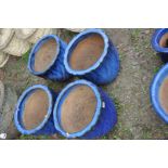 A SET OF FOUR BLUE GLAZED PLANT POTS with swirled fluting to body, 38cm in diameter and 35cm high