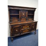 AN EARLY 20TH CENTURY OAK DRESSER, the top section with two open shelves flanking a single