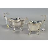 A PAIR OF GEORGE V SILVER SAUCE BOATS, of wavy oval form, gadrooned rims, scroll over 'C' shaped