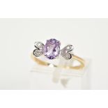 A 9CT GOLD AMETHYST AND DIAMOND RING, set with a central oval cut amethyst flanked with single cut
