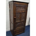 AN 18TH AND LATER OAK HALL ROBE, the single panelled door with various carved panels, revealing