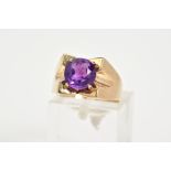 A 9CT GOLD AMETHYST RING, set with a central claw set, circular cut amethyst, within a square