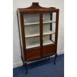 AN EDWARDIAN MAHOGANY DOUBLE DOOR DISPLAY CABINET with strung inlay, shaped gallery top, four