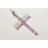 A 9CT WHITE GOLD CROSS PENDANT, set with rectangular cut pink cubic zirconia, to a plain polished