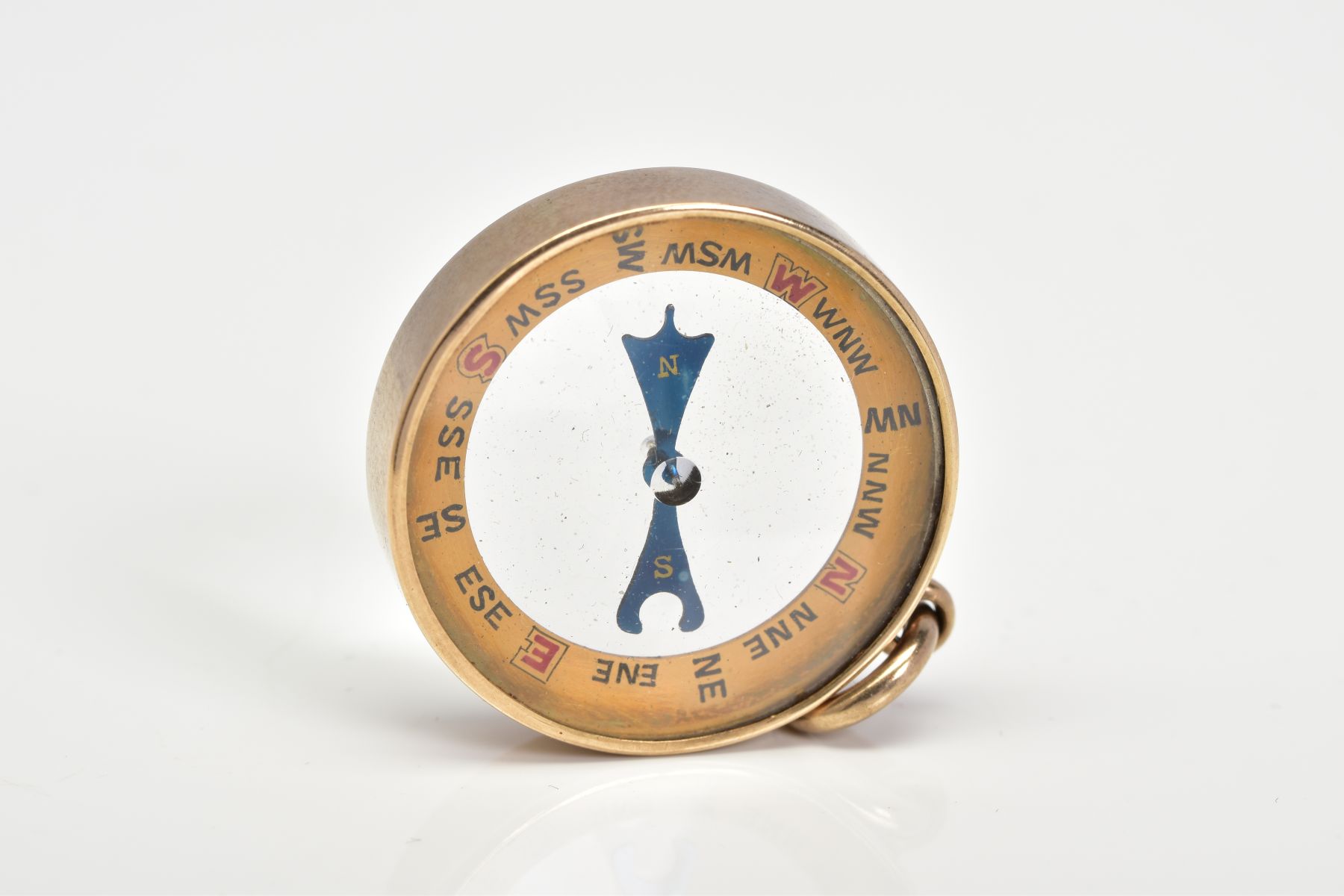 A VICTORIAN YELLOW METAL COMPASS FOB, of circular design, glass panels, blue hands, yellow metal