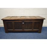 AN 18TH CENTURY OAK COFFER, with four linenfold panels to the front and the triple panel top with