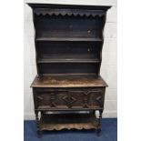 AN EARLY 20TH CENTURY OAK DRESSER, the top with double shelves, above two geometric fronted